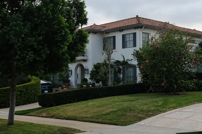 White stucco Mediterranean house with a red tile roof